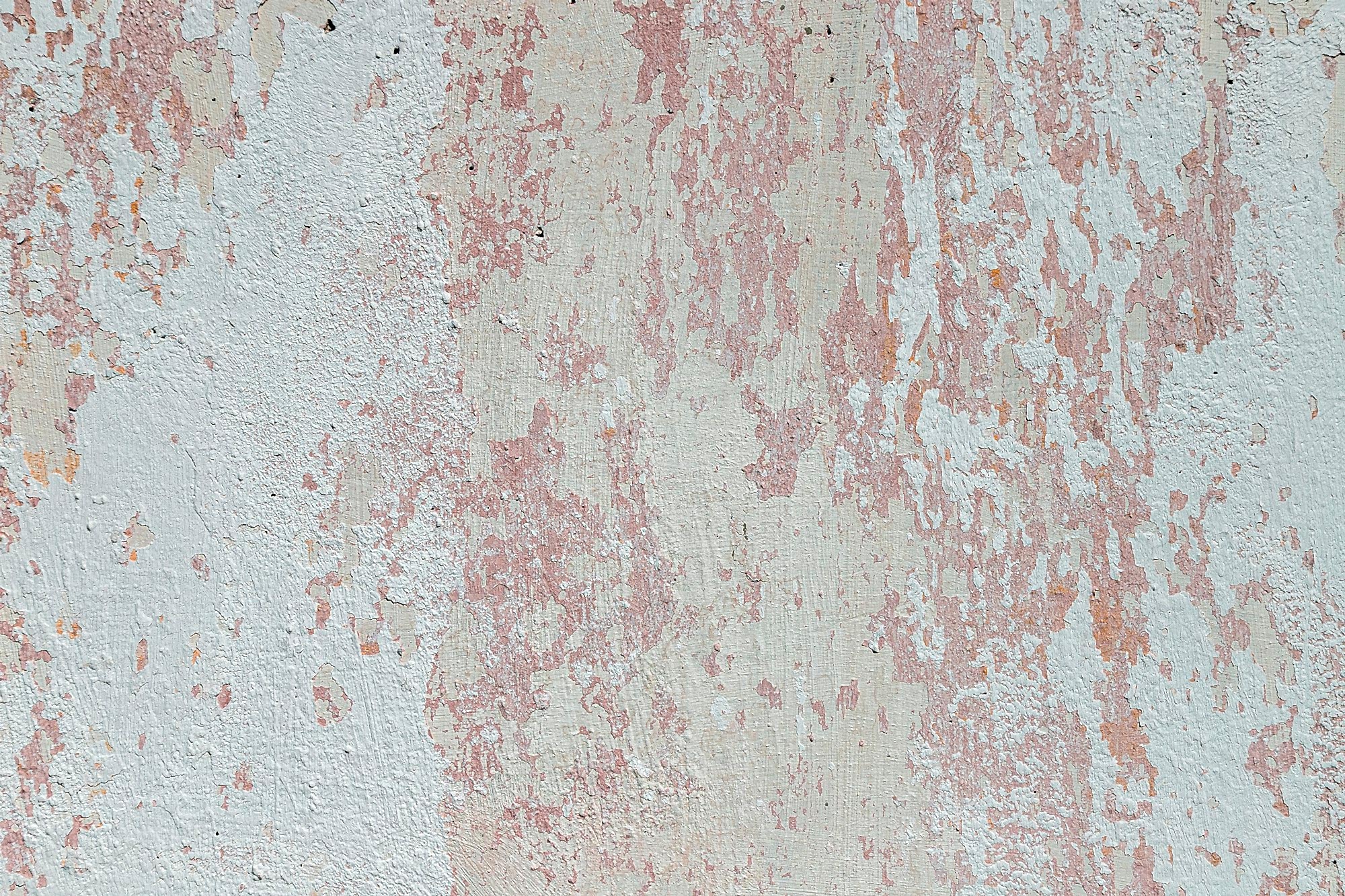 Peeling whitewash on a plaster wall